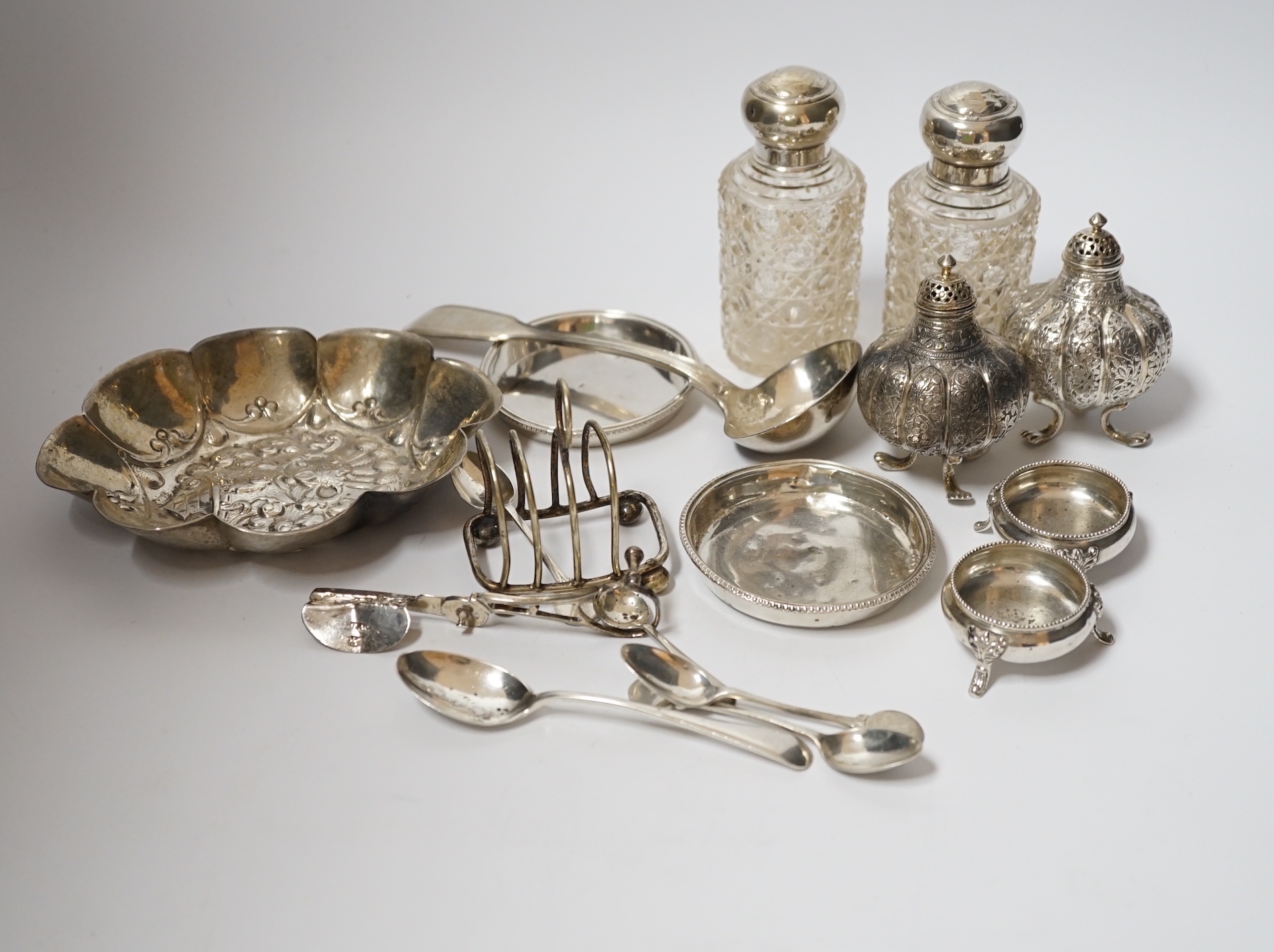A group of small mainly silver or white metal items, including salts, dishes, flatware, etc.